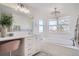 Elegant bathroom with soaking tub, double vanity, and large window at 415 S Snowmass Cir, Superior, CO 80027