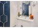 Stylish bathroom with a modern vanity and a navy blue accent wall at 415 S Snowmass Cir, Superior, CO 80027