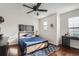 Modern bedroom with a metal framed bed, hardwood floors, and plenty of natural light at 415 S Snowmass Cir, Superior, CO 80027