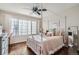 Bright bedroom with a canopy bed, hardwood floors, and ample natural light at 415 S Snowmass Cir, Superior, CO 80027