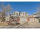 Two-story home with gray siding, brick accents, and a three-car garage at 415 S Snowmass Cir, Superior, CO 80027