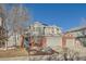 Two-story home with gray siding, brick accents, and a three-car garage at 415 S Snowmass Cir, Superior, CO 80027