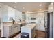 Modern kitchen with white cabinets, granite countertops, and stainless steel appliances at 415 S Snowmass Cir, Superior, CO 80027