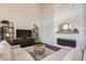 Living room with a stone fireplace and built-in shelving at 415 S Snowmass Cir, Superior, CO 80027