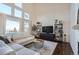 Spacious living room featuring large windows, hardwood floors, and a sectional sofa at 415 S Snowmass Cir, Superior, CO 80027