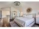 Luxurious main bedroom with a large bed, chandelier, and hardwood floors at 415 S Snowmass Cir, Superior, CO 80027