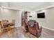 Spacious recreational room with wood-look flooring and a large screen TV at 1297 Black Haw St, Elizabeth, CO 80107