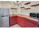 The finished basement wet bar is equipped with butcher block counters, stainless appliances, and shelving at 1297 Black Haw St, Elizabeth, CO 80107