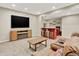 Entertainment area in basement includes a wet bar and a TV with a fireplace at 1297 Black Haw St, Elizabeth, CO 80107