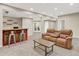 Spacious basement area with custom wet bar, a comfortable seating area, and neutral carpeting at 1297 Black Haw St, Elizabeth, CO 80107