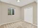 Finished basement bedroom features a large window, neutral carpet and a closet with double doors at 1297 Black Haw St, Elizabeth, CO 80107