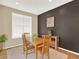 Charming dining room featuring a wooden table, chairs, and natural light from the large window at 1297 Black Haw St, Elizabeth, CO 80107