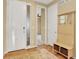 Warm entryway features hardwood floors, natural light, and a convenient bench with storage at 1297 Black Haw St, Elizabeth, CO 80107
