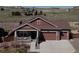 Charming exterior of a two-story home with a three car garage and covered porch in a suburban community at 1297 Black Haw St, Elizabeth, CO 80107