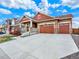 Attractive exterior featuring a well-manicured lawn, a three car garage, and a welcoming front porch at 1297 Black Haw St, Elizabeth, CO 80107