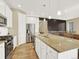 Well-lit kitchen showcasing granite island, stainless steel appliances, and hardwood floors at 1297 Black Haw St, Elizabeth, CO 80107