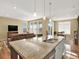 Spacious kitchen island with granite countertops overlooking the open living room and dining area at 1297 Black Haw St, Elizabeth, CO 80107