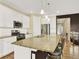Bright kitchen featuring a granite island with pendant lighting, stainless steel appliances, and white cabinets at 1297 Black Haw St, Elizabeth, CO 80107