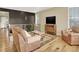 Spacious living room featuring hardwood floors, large windows, and comfortable seating at 1297 Black Haw St, Elizabeth, CO 80107
