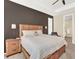 Spacious main bedroom featuring a decorative wood headboard, side tables, and sitting area near the bathroom at 1297 Black Haw St, Elizabeth, CO 80107
