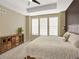 Comfortable main bedroom with a tray ceiling, neutral walls, and lots of natural light from large windows at 1297 Black Haw St, Elizabeth, CO 80107