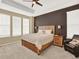 Relaxing main bedroom showcasing a decorative wood headboard and matching side tables, plus a comfy chair at 1297 Black Haw St, Elizabeth, CO 80107