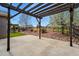 Beautiful backyard patio with wooden pergola, rock features and a view of the landscaped yard at 15851 Josephine Cir, Brighton, CO 80602