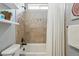 Neutral bathroom with a shower-tub combo, tiled walls, and decorative accents at 15851 Josephine Cir, Brighton, CO 80602