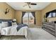 Bright bedroom with large windows, ceiling fan, and neutral carpet flooring at 15851 Josephine Cir, Brighton, CO 80602