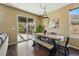 Dining room with wooden table and chairs, sliding doors to a covered patio at 15851 Josephine Cir, Brighton, CO 80602