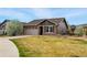 Charming single-story home featuring a stone facade, attached garage, and well-maintained lawn at 15851 Josephine Cir, Brighton, CO 80602