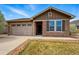 Charming single-story home featuring a stone facade, attached garage, and well-maintained lawn at 15851 Josephine Cir, Brighton, CO 80602