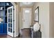 Inviting foyer featuring a wood floor, front door, and accent bench with a view to the office at 15851 Josephine Cir, Brighton, CO 80602