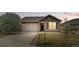 Charming single-Gathering home featuring a stone facade, well-maintained lawn, and attached two-car garage at 15851 Josephine Cir, Brighton, CO 80602