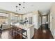 Spacious kitchen with a large center island, modern pendant lighting, and stainless steel appliances at 15851 Josephine Cir, Brighton, CO 80602
