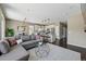 Open-concept design featuring a modern living room seamlessly connected to the kitchen with stainless steel appliances at 15851 Josephine Cir, Brighton, CO 80602