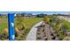 A walking path cuts through a beautiful community park with a blue sculpture off to one side at 18714 E 99Th Ave, Commerce City, CO 80022