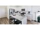Modern kitchen features stainless steel appliances, granite countertops, and white cabinetry at 18714 E 99Th Ave, Commerce City, CO 80022