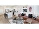 Open-concept living room next to the kitchen offers a cozy space with modern decor and white walls at 18714 E 99Th Ave, Commerce City, CO 80022