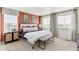 Main bedroom with a king-sized bed, modern decor, and plenty of natural light from two windows at 18714 E 99Th Ave, Commerce City, CO 80022