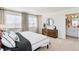 Bright main bedroom with two windows, stylish decor, and an ensuite bathroom at 18714 E 99Th Ave, Commerce City, CO 80022