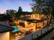 Private backyard with hot tub, outdoor kitchen, and cozy fire pit area at 2400 S Columbine St, Denver, CO 80210