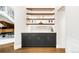 Stylish bar with dark cabinets, light countertops, floating shelves and under cabinet lighting at 2400 S Columbine St, Denver, CO 80210