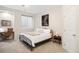 Well-lit bedroom features a metal bed frame, a desk, and neutral-colored decor at 2400 S Columbine St, Denver, CO 80210
