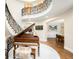 Grand foyer featuring a curved staircase with wrought iron railings and a baby grand piano at 2400 S Columbine St, Denver, CO 80210