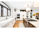 Bright kitchen featuring stainless steel appliances, white cabinetry, and eat-in area at 2400 S Columbine St, Denver, CO 80210