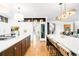 Bright, modern kitchen with pendant lighting, large island, and stainless steel appliances at 2400 S Columbine St, Denver, CO 80210