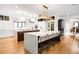 Bright and airy kitchen with dual islands, modern appliances, and stylish seating and piano nearby at 2400 S Columbine St, Denver, CO 80210