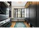 Mud room with modern washer/dryer, storage cabinets, and a window seat at 2400 S Columbine St, Denver, CO 80210