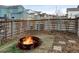 Backyard with fire pit and seating, wood fence, and landscaping for outdoor enjoyment at 8984 Eagle River St, Littleton, CO 80125